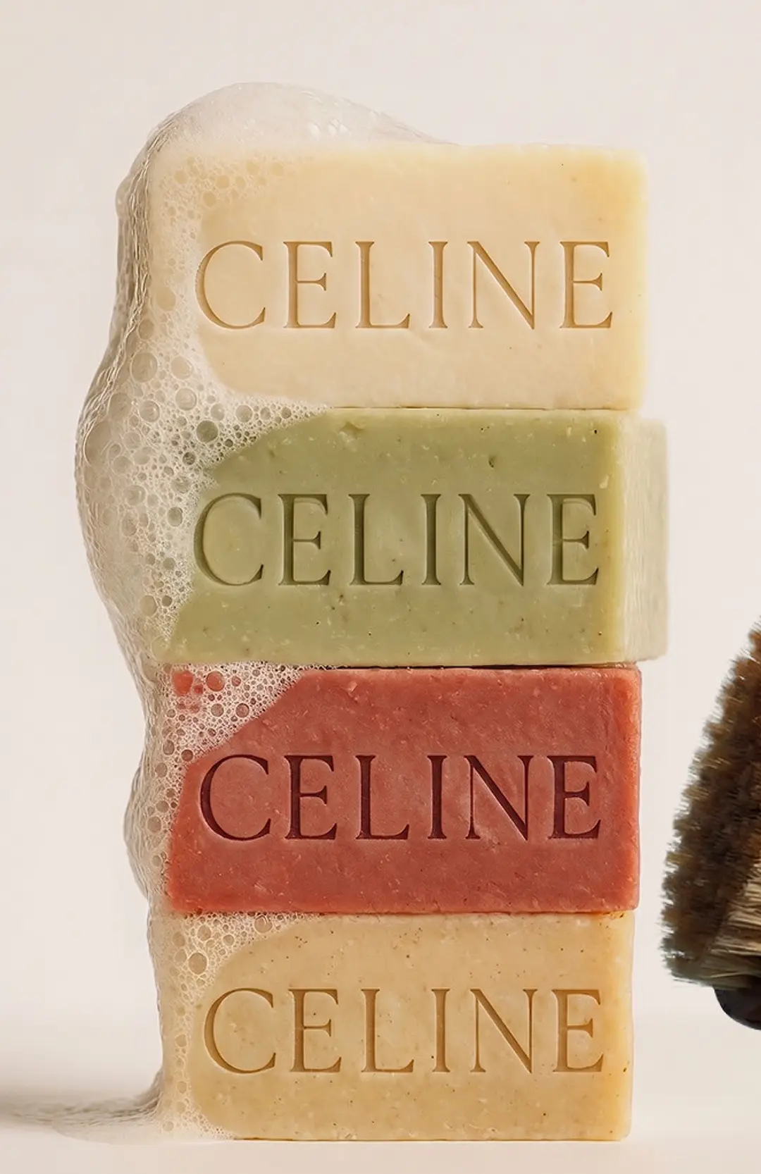 Four soap bars stacked high, each pressed with the word CELINE.
